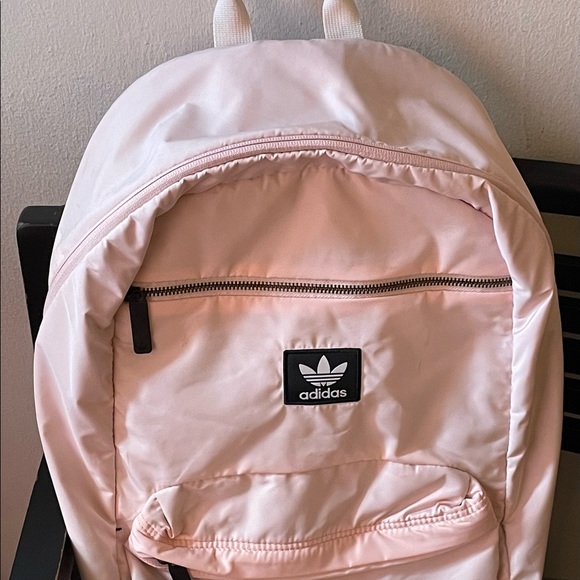 A light pink, Adidas book bag.